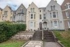 Front of house with garden and benches