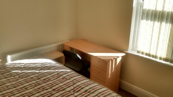 Double bed and desk in available room 