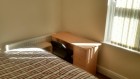 Double bed and desk in available room 