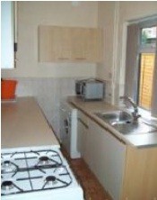 kitchen has a washing machine, fridge/freezer, gas hob, microwave 