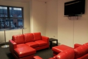 communal lounge with flat screen TV and dining area