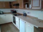Kitchen with hob, oven, fridge, freezer, microwave and plenty of cupboard space