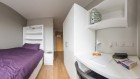 En-suite room with mattress desk chair and mini safe for valuables 