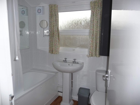 Bathroom with bath and electric shower overhead. Second WC on ground floor