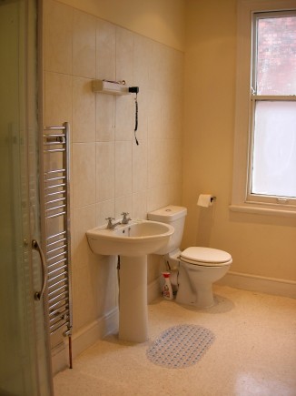 Spacious bathroom with heated towel rail