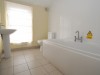 bathroom provided with bath and shower and plenty of storage for all thoughs products